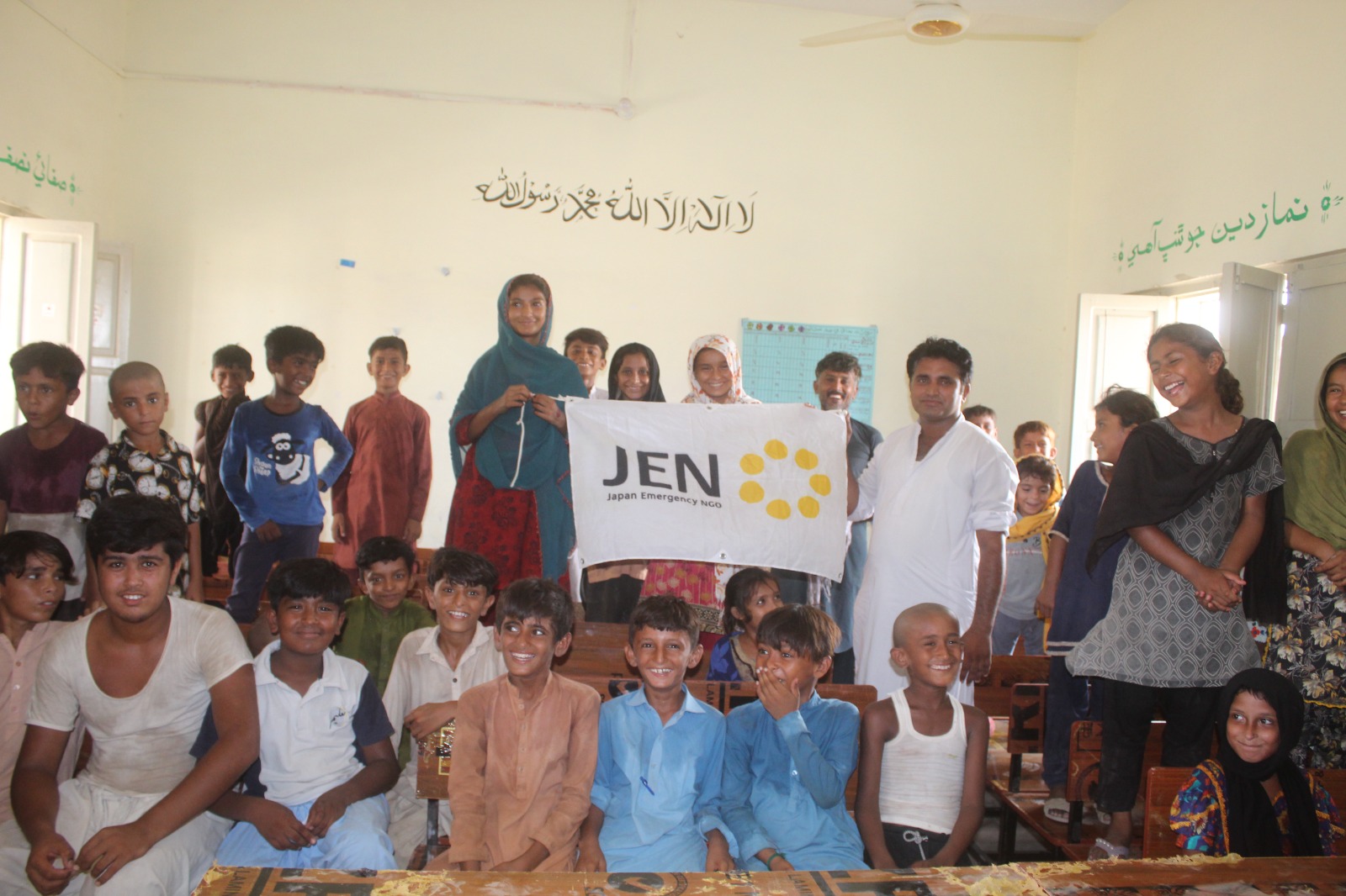 Students sitting on the new benches instead of the floor for the first time since the floods