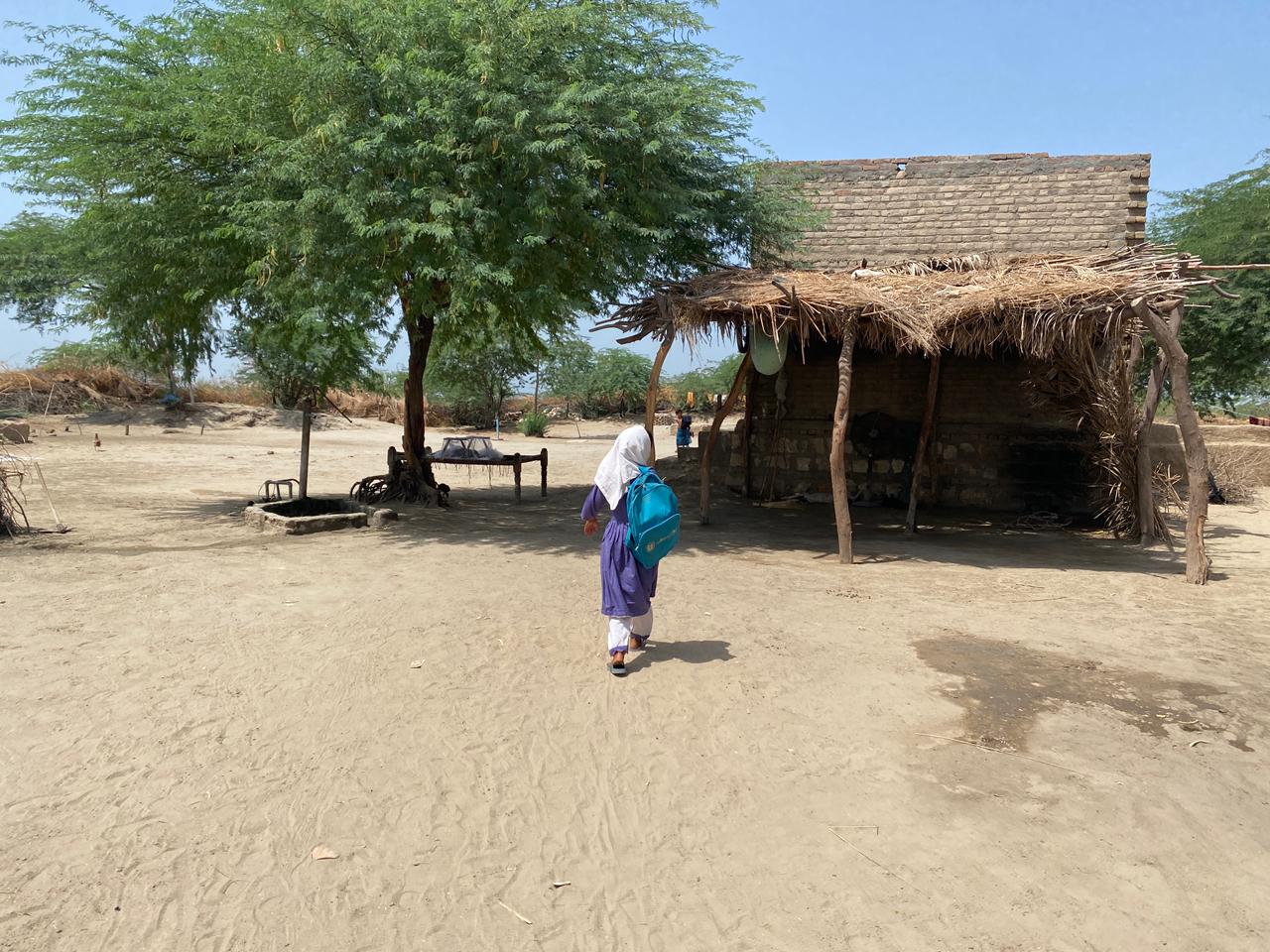 Gulzadi walking to school with her backpack on